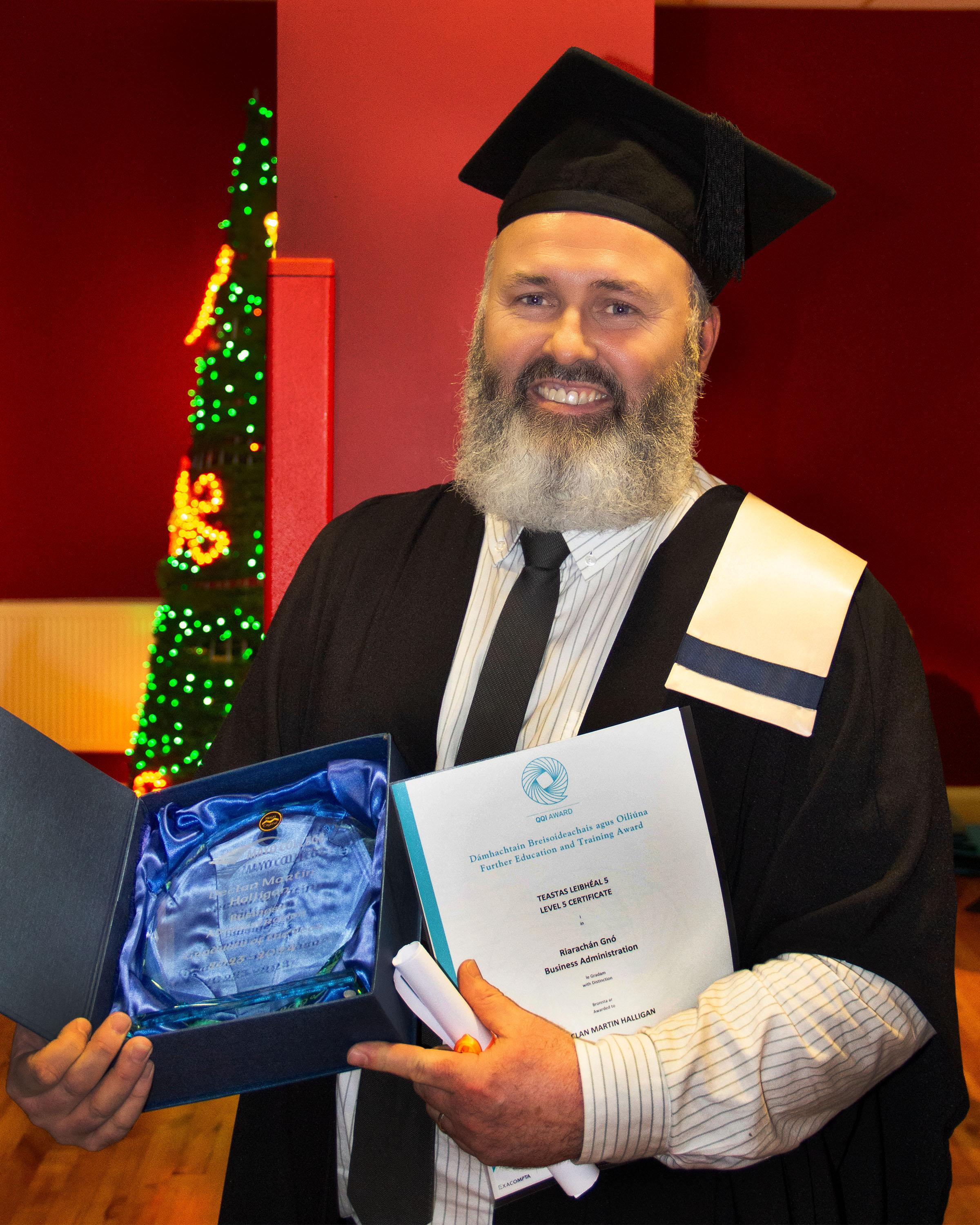 Picture of Declan receiving his graduation award